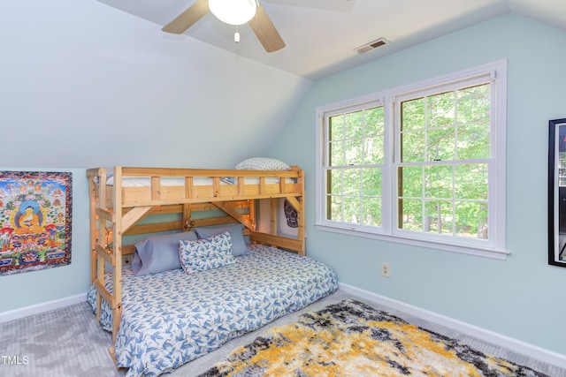 bedroom featuring lofted ceiling, baseboards, carpet flooring, and a ceiling fan
