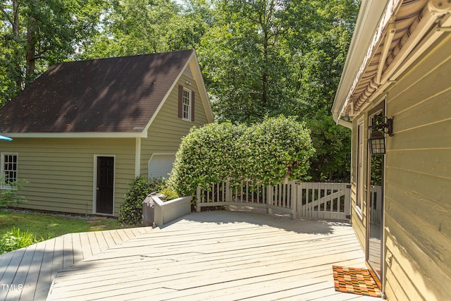 wooden terrace with a garage and an outdoor structure
