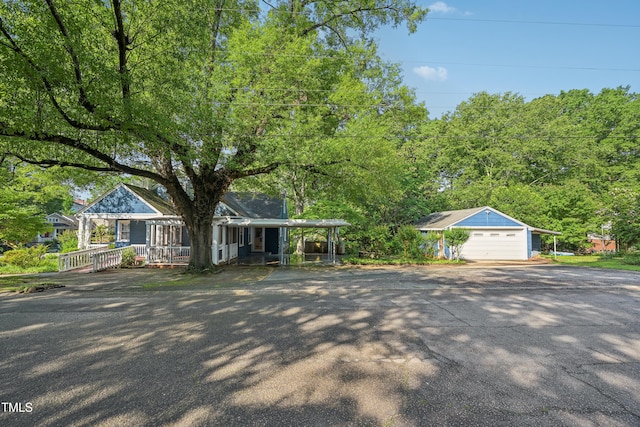 view of front facade with a porch, a garage, and driveway