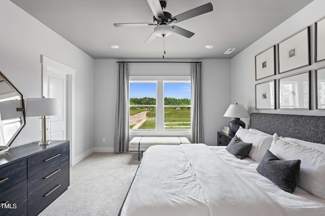 bedroom with light carpet, baseboards, and a ceiling fan
