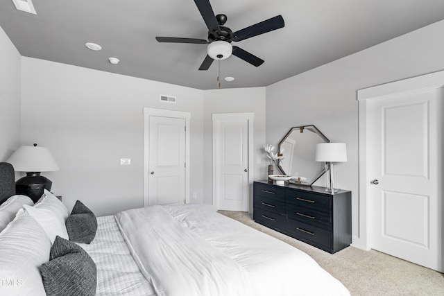 bedroom featuring light colored carpet and ceiling fan