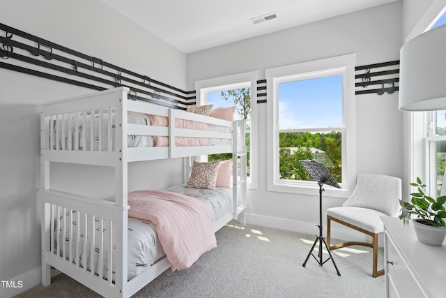 carpeted bedroom featuring baseboards