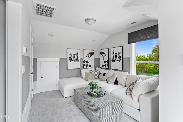 carpeted living area with lofted ceiling