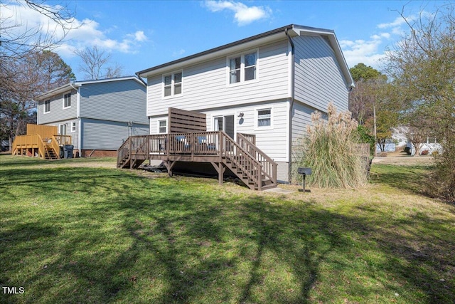 back of house with a wooden deck, stairs, and a yard