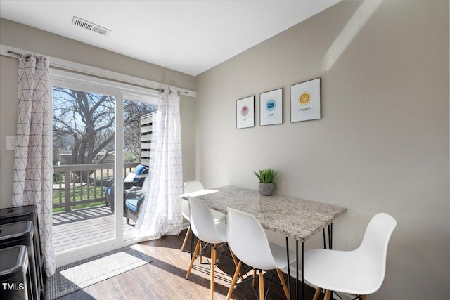 dining area with wood finished floors