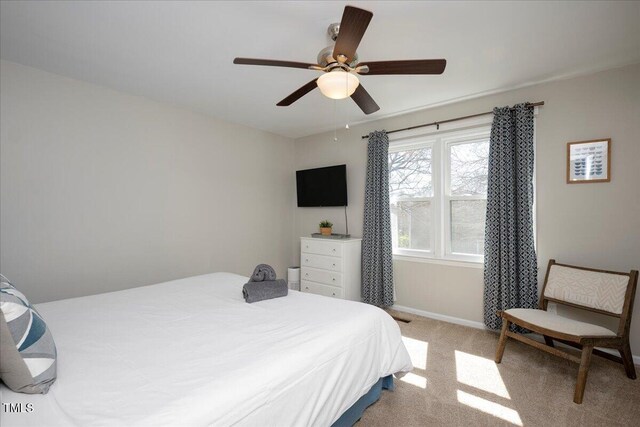 bedroom with carpet floors, baseboards, and a ceiling fan