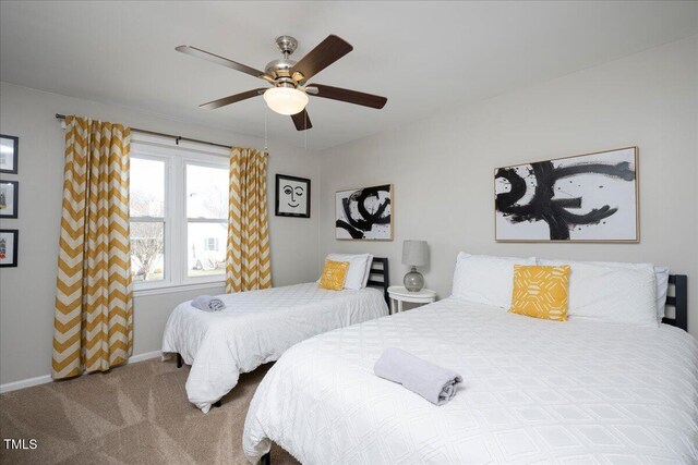 carpeted bedroom with baseboards and ceiling fan