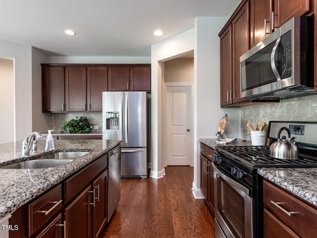 437 Henmore Brook Dr, Cary, NC 27519 - kitchen with stainless steel appliances, a sink, dark wood-style flooring, light stone counters, and recessed lighting