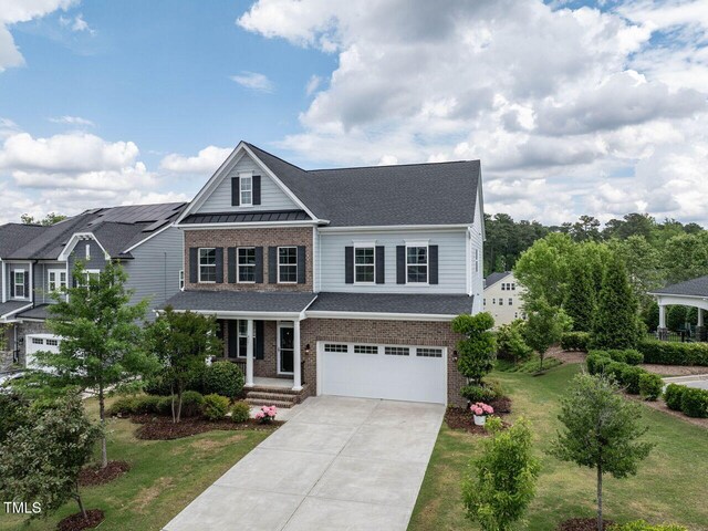 437 Henmore Brook Dr, Cary, NC 27519 - traditional home featuring brick siding, a garage, driveway, and a front yard
