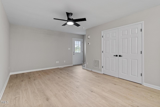 353 E Williams St, Angier, NC 27501 - unfurnished bedroom featuring light wood-style flooring, baseboards, ceiling fan, and a closet