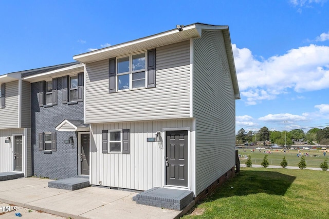 353 E Williams St, Angier, NC 27501 - townhome / multi-family property featuring a front yard, board and batten siding, and crawl space