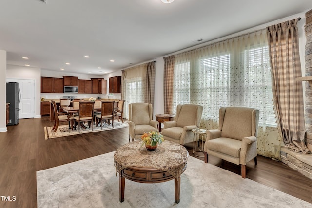 living area with dark wood finished floors and recessed lighting