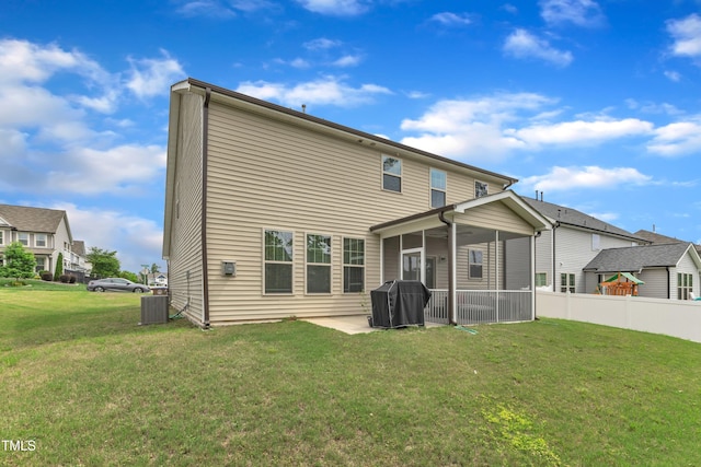 rear view of house featuring a sunroom and cooling unit