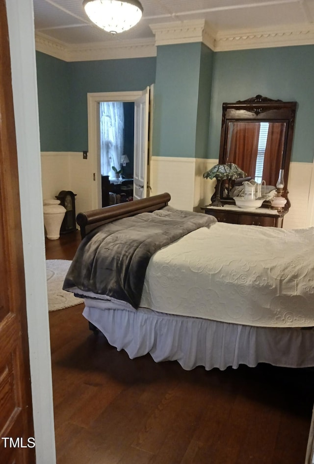 417 S Main St, Warrenton, NC 27589 - bedroom featuring a wainscoted wall, crown molding, wood finished floors, and multiple windows