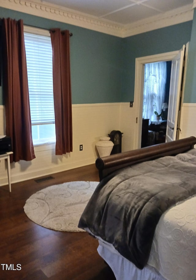 417 S Main St, Warrenton, NC 27589 - bedroom featuring a wainscoted wall, crown molding, and wood finished floors