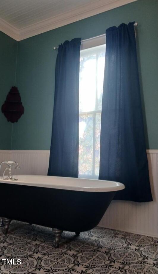 417 S Main St, Warrenton, NC 27589 - full bathroom featuring wainscoting, a soaking tub, and crown molding