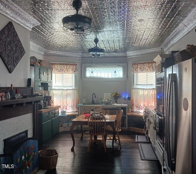 417 S Main St, Warrenton, NC 27589 - kitchen with freestanding refrigerator, an ornate ceiling, ornamental molding, dark wood finished floors, and plenty of natural light