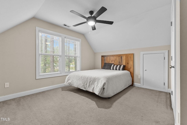 bedroom with vaulted ceiling, baseboards, carpet floors, and ceiling fan