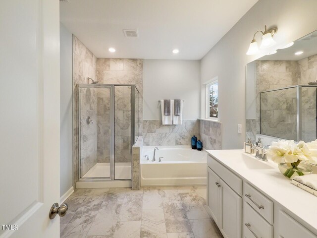 265 Sutherland Dr, Franklinton, NC 27525 - full bathroom featuring a stall shower, a garden tub, vanity, recessed lighting, and marble finish floors