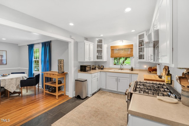 202 Hilltop Ave, Garner, NC 27529 - kitchen with a sink, wall chimney exhaust hood, white cabinets, light countertops, and recessed lighting