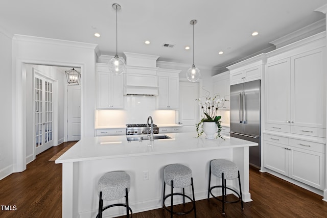 620 Wade Ave Unit 505, Raleigh, NC 27605 - kitchen with built in fridge, a sink, white cabinetry, a breakfast bar area, and recessed lighting