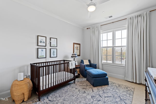 620 Wade Ave Unit 505, Raleigh, NC 27605 - bedroom with light carpet, baseboards, a nursery area, ornamental molding, and a ceiling fan