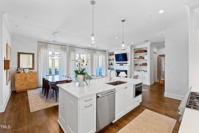 620 Wade Ave Unit 505, Raleigh, NC 27605 - kitchen with stainless steel dishwasher, a sink, crown molding, open floor plan, and an island with sink