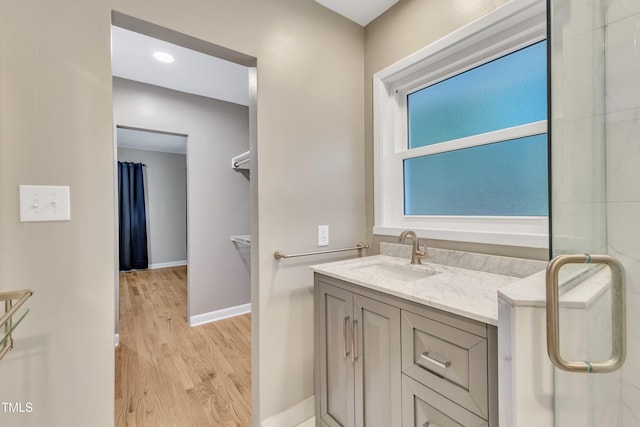 2600 Wade Ave, Raleigh, NC 27607 - bathroom with wood finished floors, baseboards, and vanity