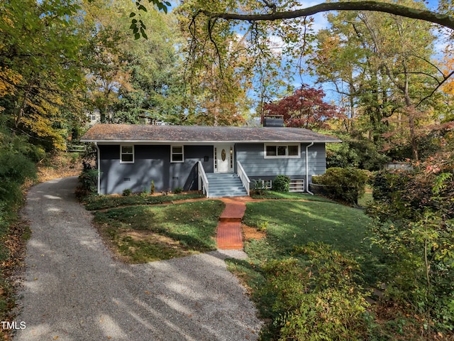 2600 Wade Ave, Raleigh, NC 27607 - view of front facade featuring a chimney, a front yard, and driveway
