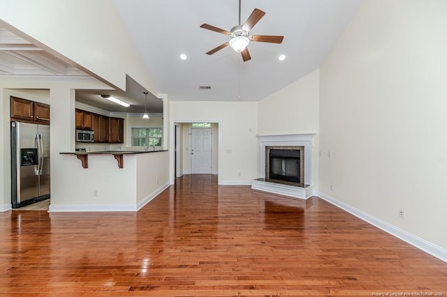 1536 Louisiana Ln, Sanford, NC 27332 - unfurnished living room featuring a ceiling fan, light wood-type flooring, recessed lighting, baseboards, and vaulted ceiling