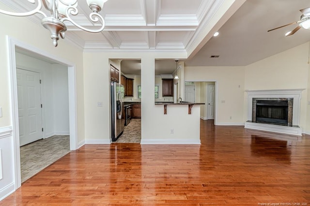 1536 Louisiana Ln, Sanford, NC 27332 - unfurnished living room featuring crown molding, a premium fireplace, light wood finished floors, coffered ceiling, and a chandelier