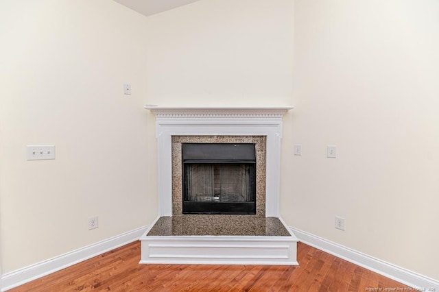 1536 Louisiana Ln, Sanford, NC 27332 - detailed view of a fireplace with raised hearth, baseboards, and wood finished floors