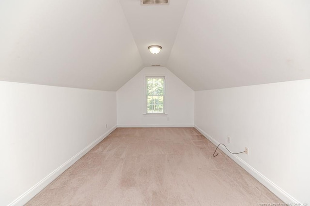 1536 Louisiana Ln, Sanford, NC 27332 - additional living space with baseboards, vaulted ceiling, and light colored carpet