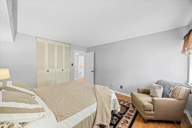 4709 Edwards Mill Rd Unit H, Raleigh, NC 27612 - bedroom with wood finished floors, baseboards, and a closet