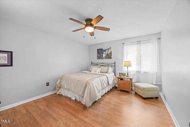 4709 Edwards Mill Rd Unit H, Raleigh, NC 27612 - bedroom with light wood finished floors, a textured ceiling, ceiling fan, and baseboards