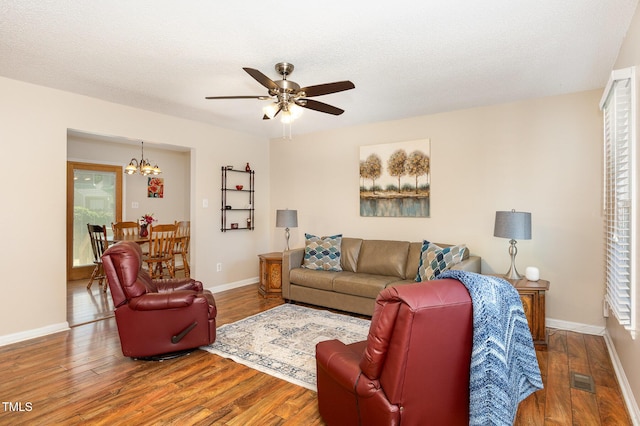 809 Maple Shade Ln, Apex, NC 27502 - living area with a chandelier, wood finished floors, a ceiling fan, and baseboards