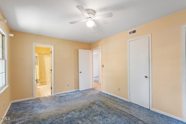 103 Castill Pl, Garner, NC 27529 - unfurnished bedroom with carpet flooring, baseboards, ensuite bathroom, a textured ceiling, and a ceiling fan