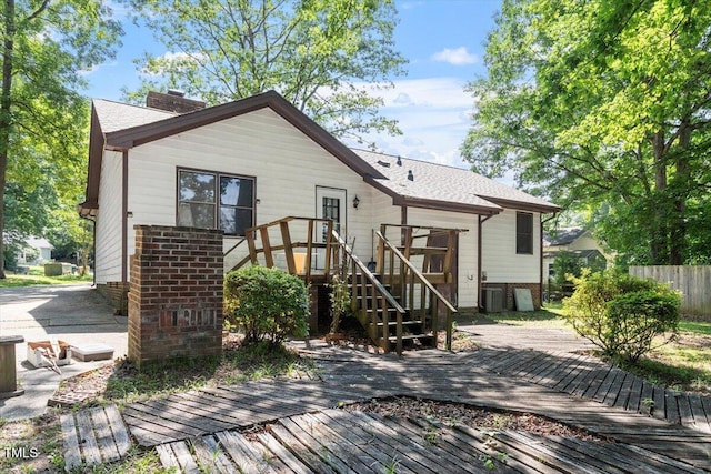 103 Castill Pl, Garner, NC 27529 - back of property with a wooden deck, a chimney, brick siding, central air condition unit, and stairs