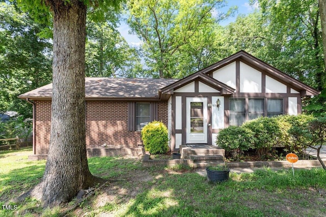 103 Castill Pl, Garner, NC 27529 - english style home featuring brick siding, roof with shingles, and a front yard