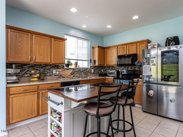 3507 Portico Ln, Durham, NC 27703 - kitchen featuring black appliances, a sink, backsplash, light tile patterned floors, and recessed lighting