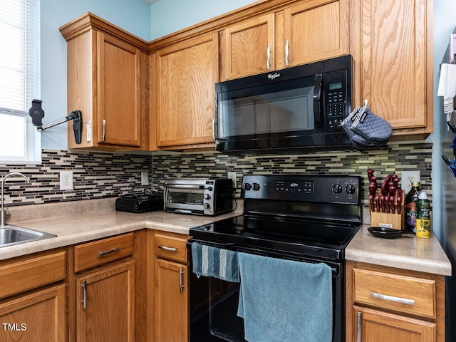 3507 Portico Ln, Durham, NC 27703 - kitchen with black appliances, light countertops, tasteful backsplash, and a sink