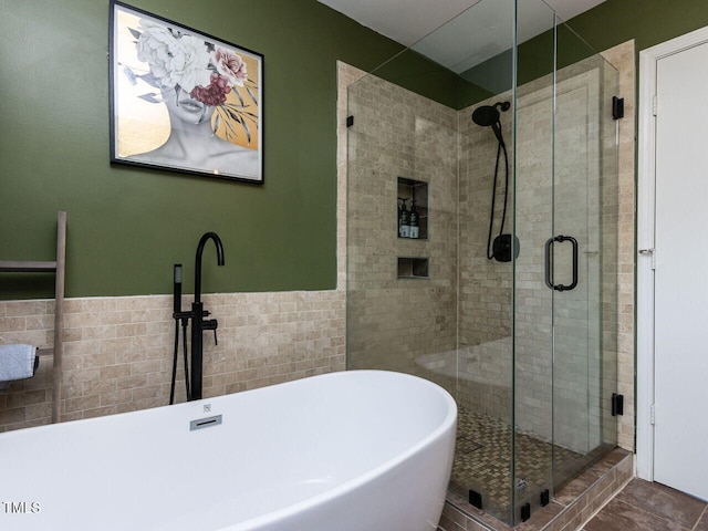 3507 Portico Ln, Durham, NC 27703 - full bathroom featuring a shower stall, tile walls, a freestanding bath, and wainscoting