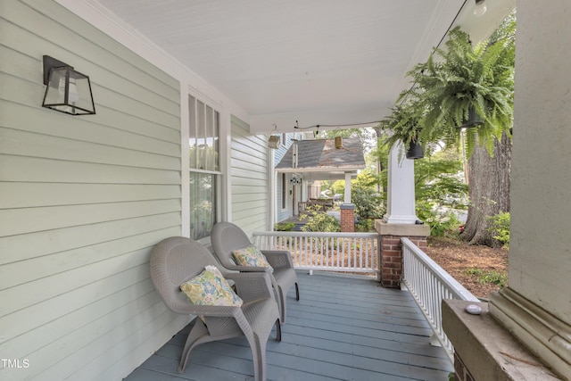 wooden terrace featuring covered porch