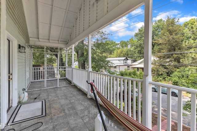 balcony featuring view of wooded area