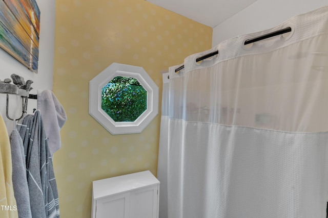 bathroom featuring wallpapered walls and a shower with curtain