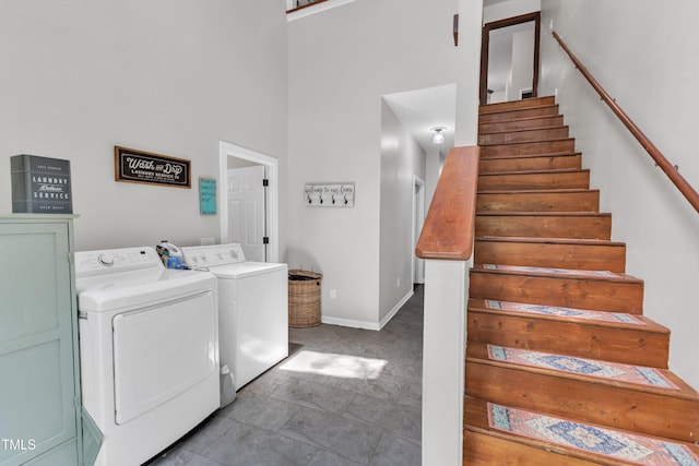 washroom featuring washing machine and dryer and baseboards