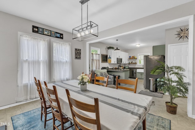 dining area featuring light tile patterned floors and a chandelier