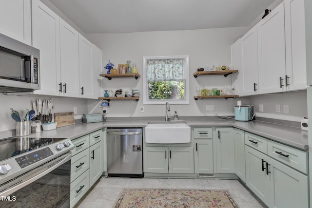 kitchen featuring stainless steel appliances, open shelves, a sink, and white cabinetry