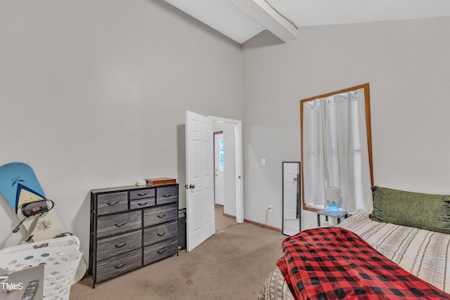 bedroom with carpet flooring, beamed ceiling, baseboards, and high vaulted ceiling