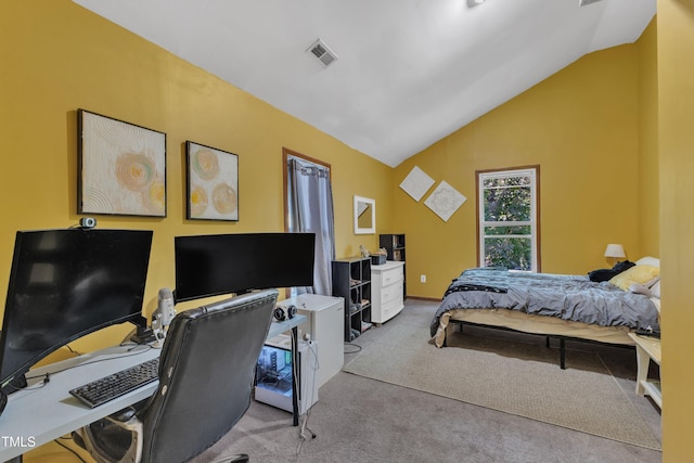 carpeted bedroom with vaulted ceiling and a desk